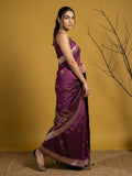 Woman in a purple saree with a yellow background
