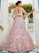 Woman in a floral lehenga with a white door and garden background