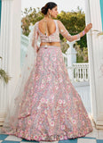 Woman in a floral lehenga with a white door and garden background