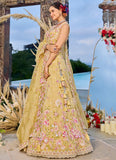 Yellow organza bridal lehenga with matching dupatta and thread work embroidery