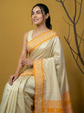 elegant yellow silk saree with contrast traditional border and tassels