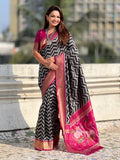 black soft silk saree with ikat motifs and zari weaving design
