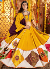 Woman in a yellow and purple traditional outfit with a decorated background