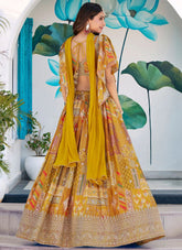Woman in a yellow and patterned traditional outfit with a floral background