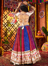 Woman in a colorful traditional outfit with a vibrant background