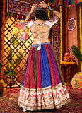 Woman in a colorful traditional outfit with a vibrant background
