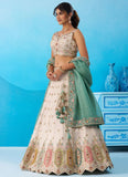 Cream embroidered tissue lehenga featuring heavy sequins, multicolor patch work and a contrasting sky blue tissue dupatta with colourful cutwork border