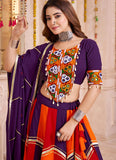 Woman wearing a traditional outfit with a colorful blouse and purple saree.