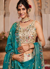 Woman in traditional embroidered outfit with jewelry against a decorative background