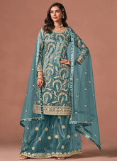 Turquoise palazzo salwar suit featuring embroidery, sequins and zari work