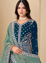 Woman wearing a traditional embroidered outfit with a plain background