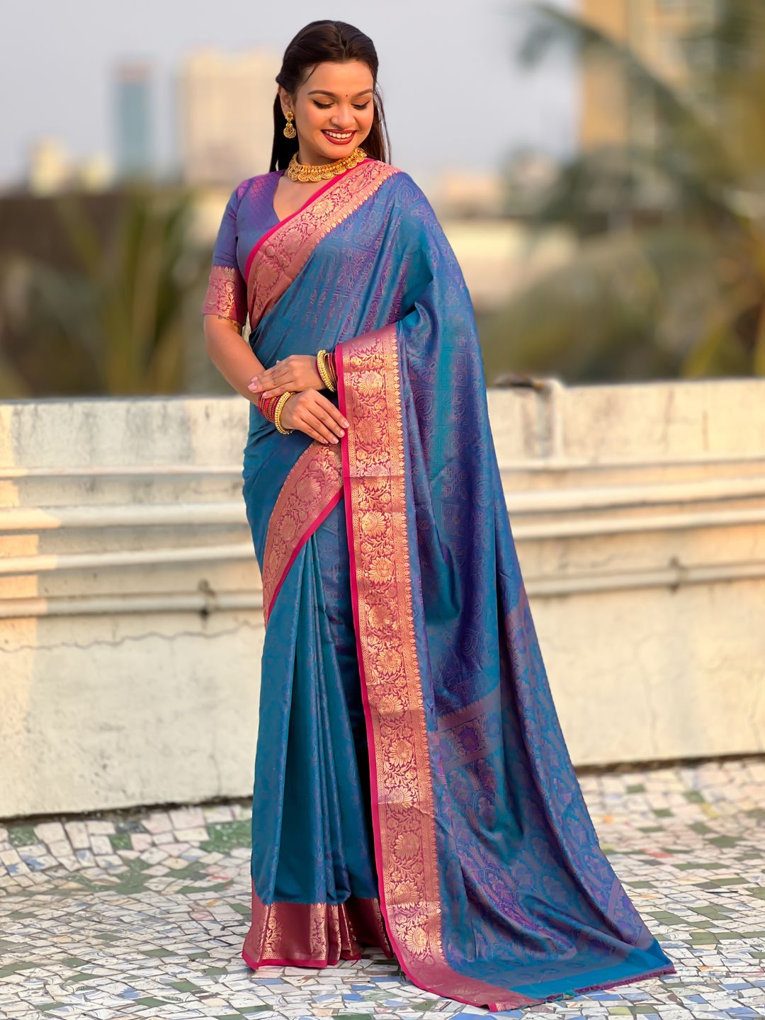 traditional blue patola saree with running pallu and brocade blouse