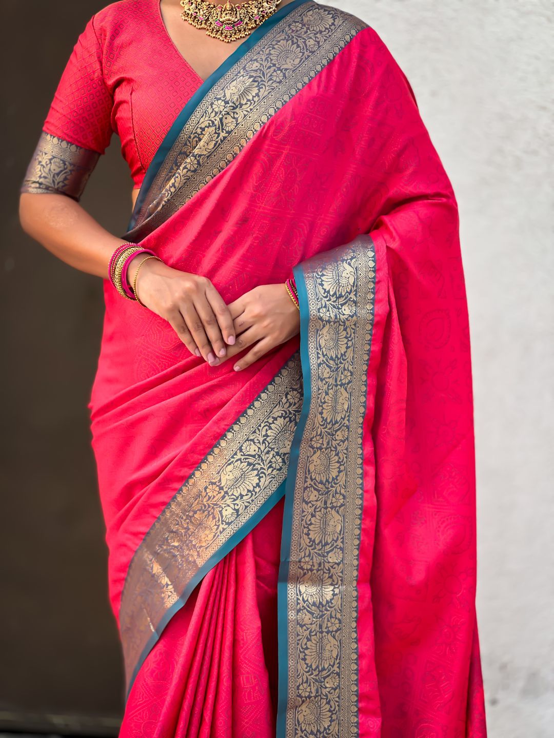 ethnic light pink saree with contrast floral border and heritage weaving