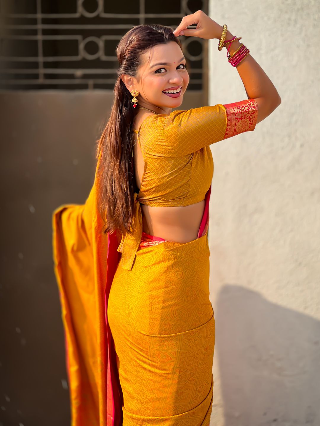 traditional yellow patola saree with running pallu and brocade blouse