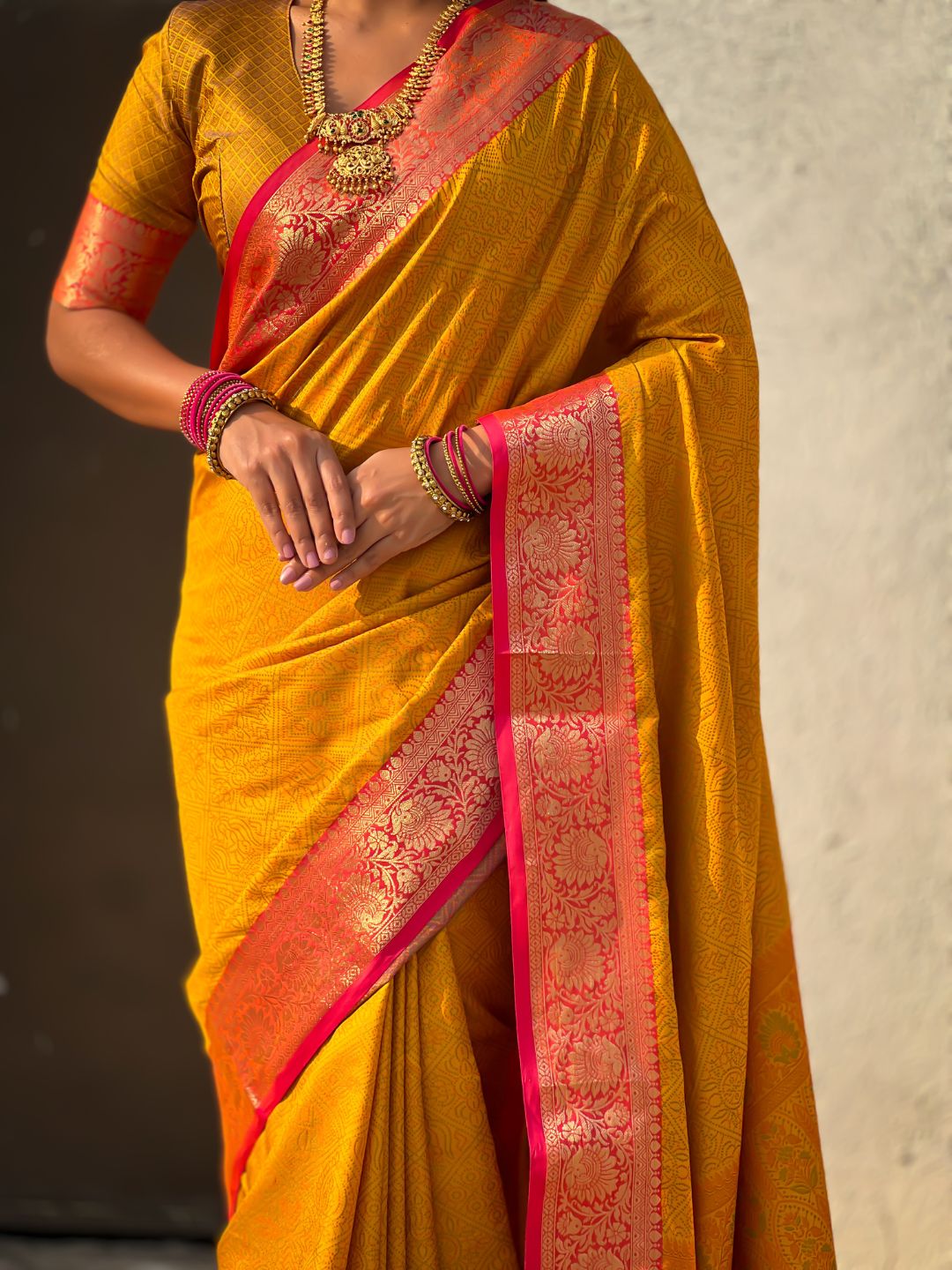 ethnic yellow saree with contrast floral border and heritage weaving
