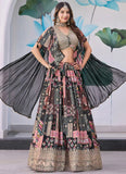 Woman wearing a traditional patterned outfit with a black dupatta against a decorative background