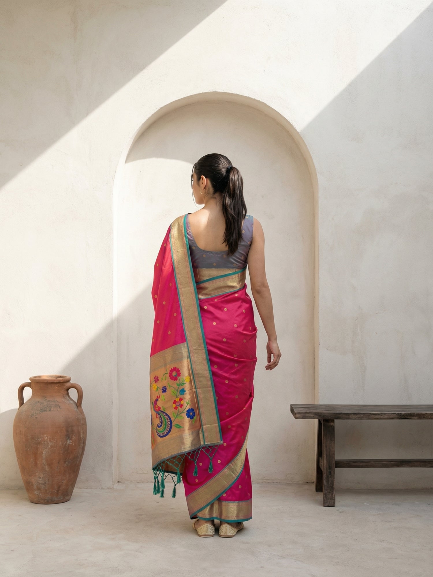ethnic pink silk saree with traditional peacock border design