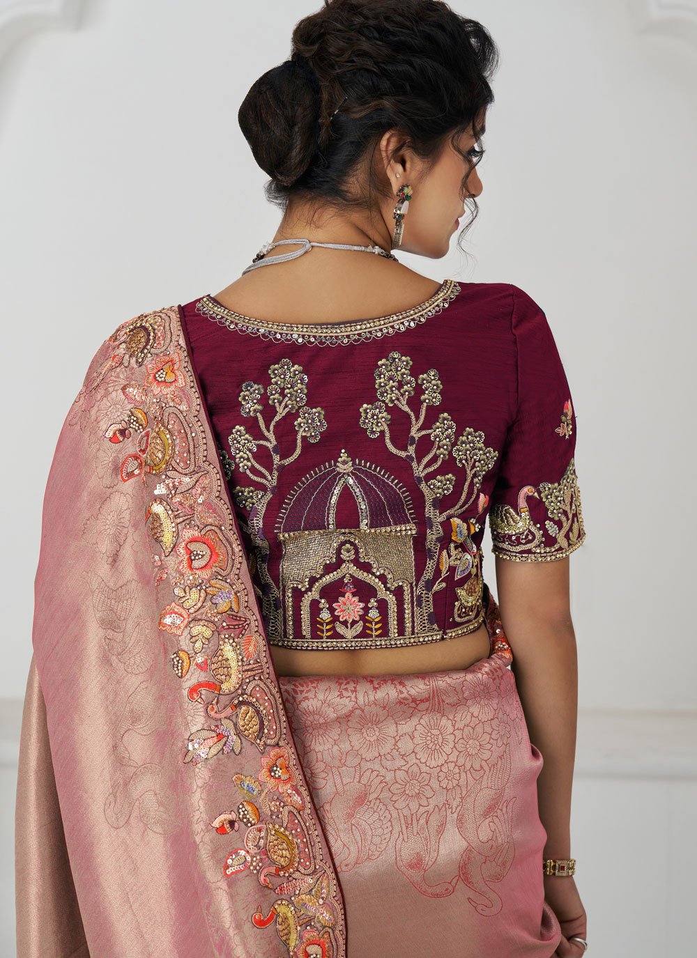 Elegant pink hue with detailed embroidery saree