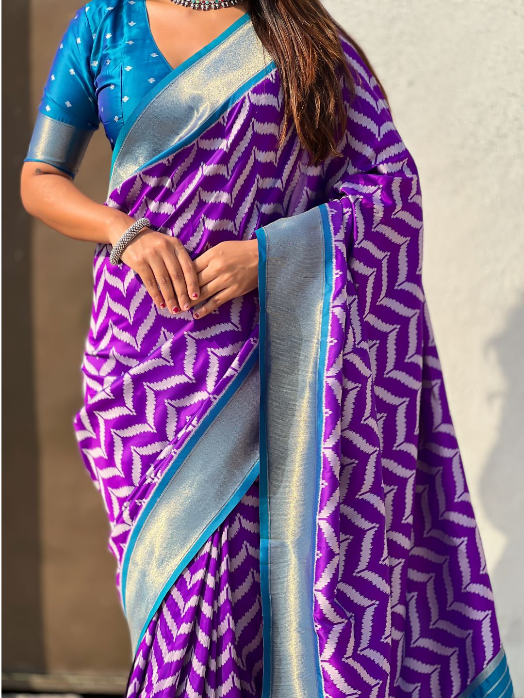 wedding wear purple silk saree with contrast blouse and heritage motifs
