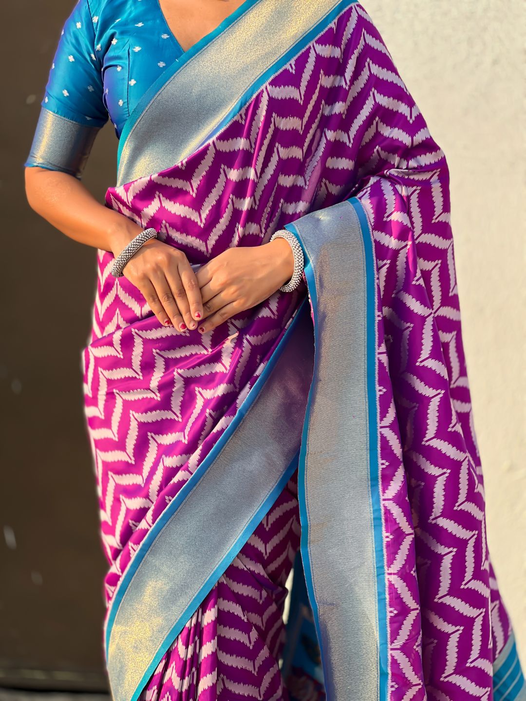 designer wine silk saree with heritage motifs and contrast blouse