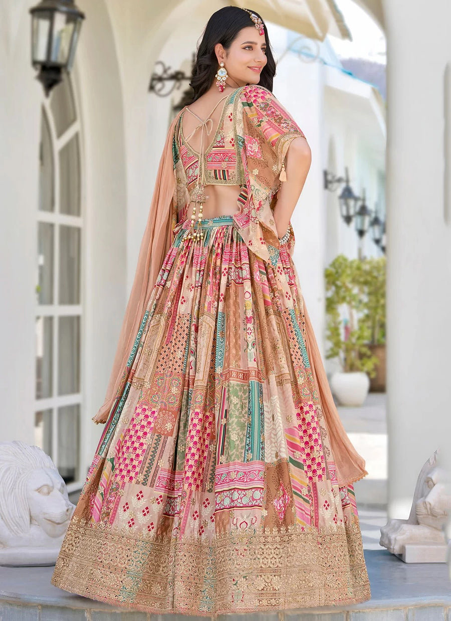 Woman wearing a colorful traditional outfit with a patterned dress and dupatta in an outdoor setting.