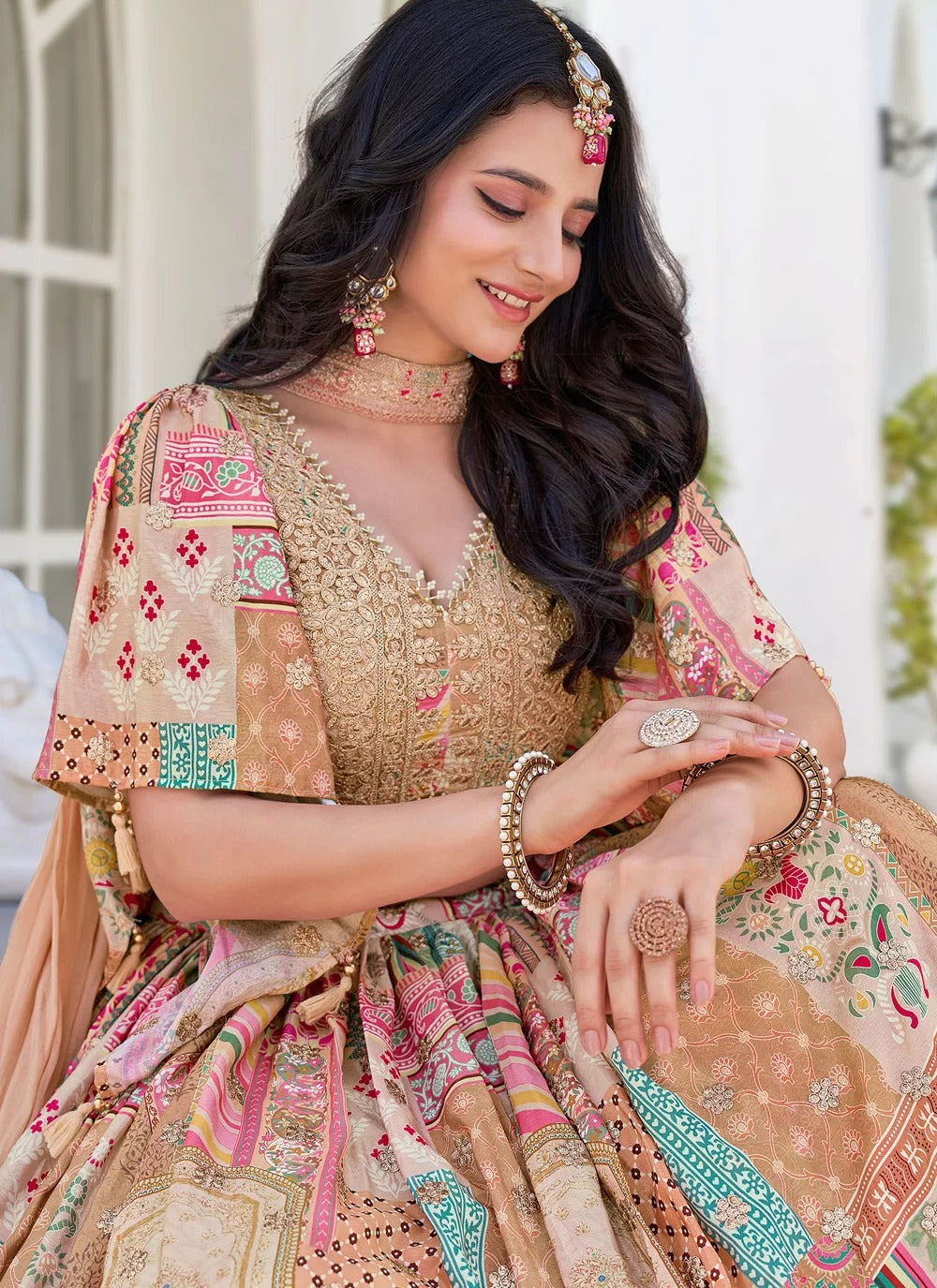 Woman in traditional embroidered outfit with jewelry, outdoors.