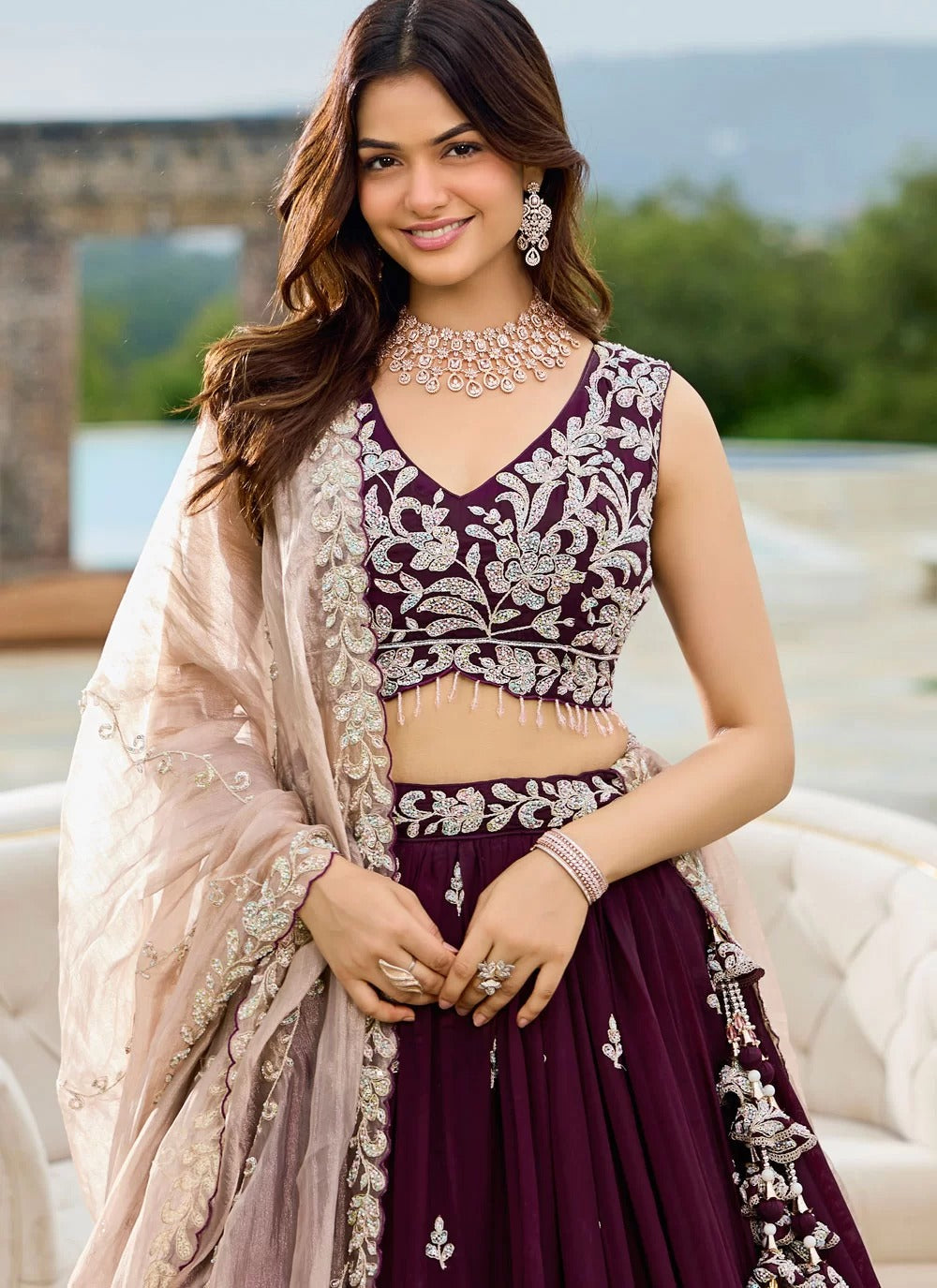 Woman in traditional outfit with intricate designs outdoors