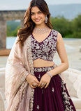 Woman in traditional outfit with intricate designs outdoors