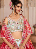 Woman wearing a traditional embroidered outfit with a floral headpiece indoors.