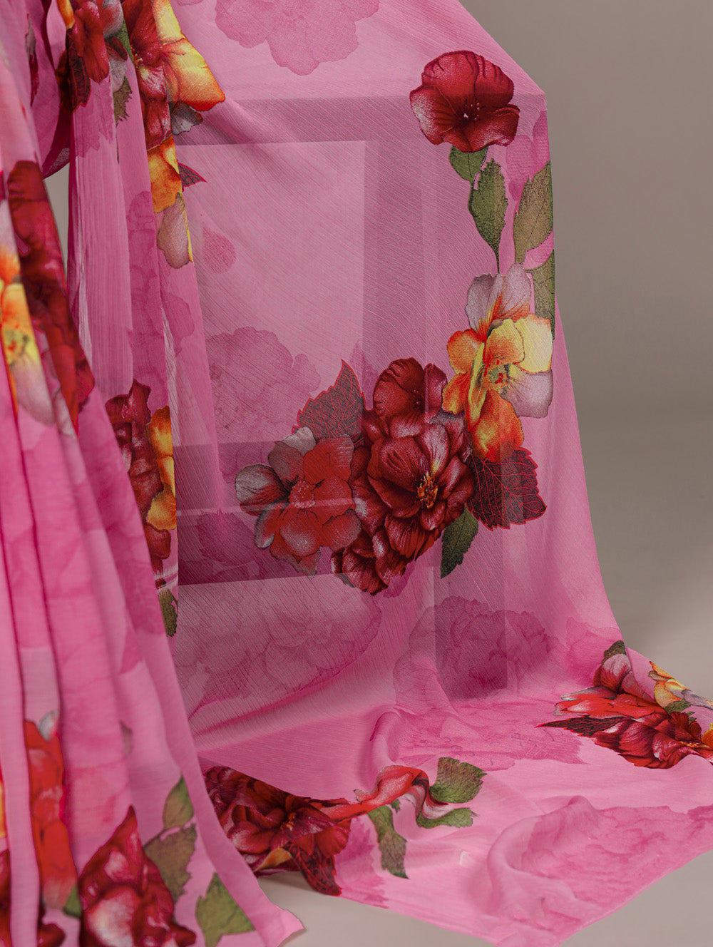 Pink fabric with floral patterns on a plain background