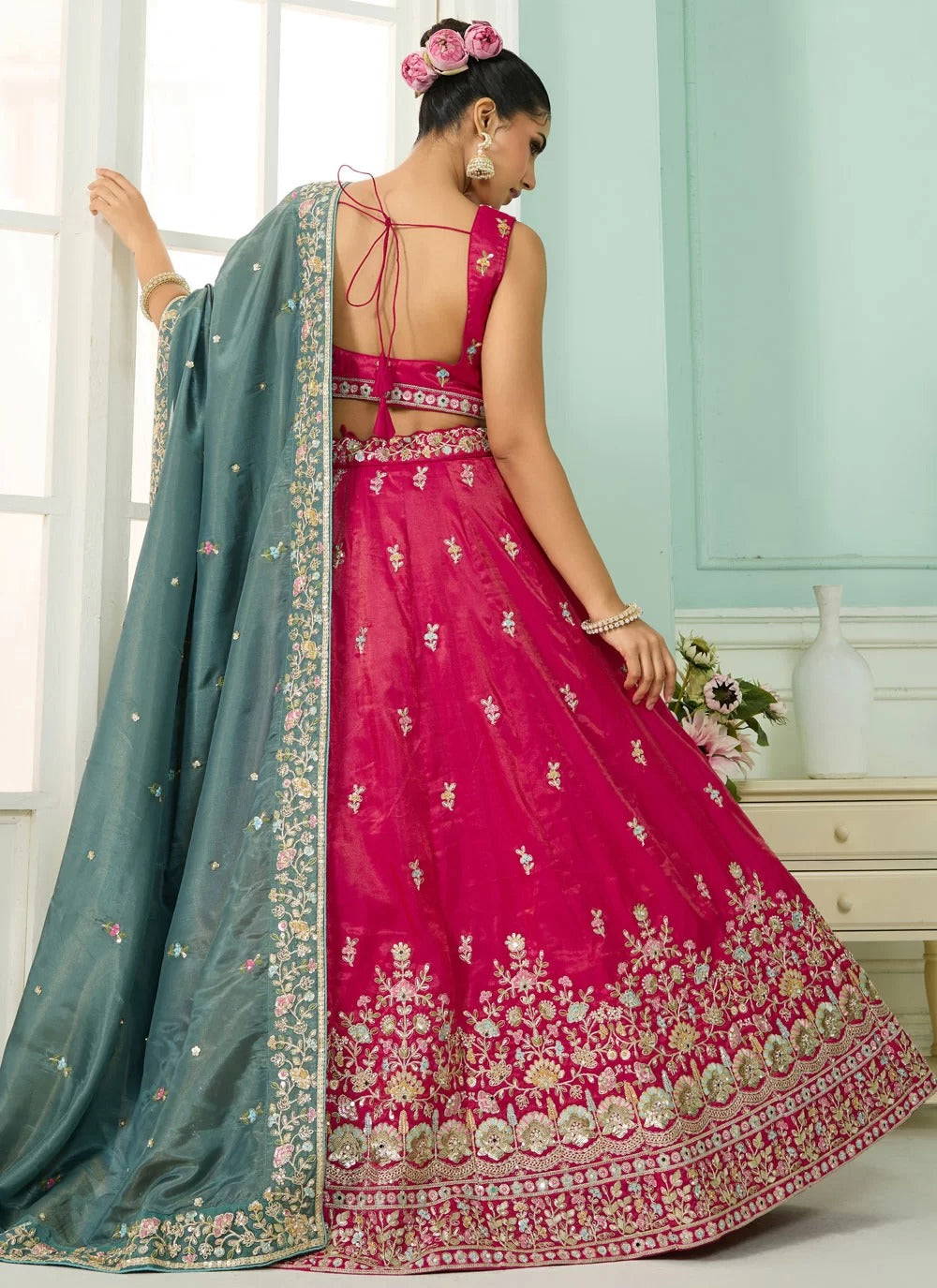 pink cosmos silk lehenga with beads, sequins, stone and thread embroidery, paired with teal dupatta and sweetheart neck blouse