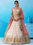 Cream tissue wedding lehenga featuring heavy sequins embroidery, multicolor patch work and a contrasting pink tissue dupatta with colourful cutwork border.