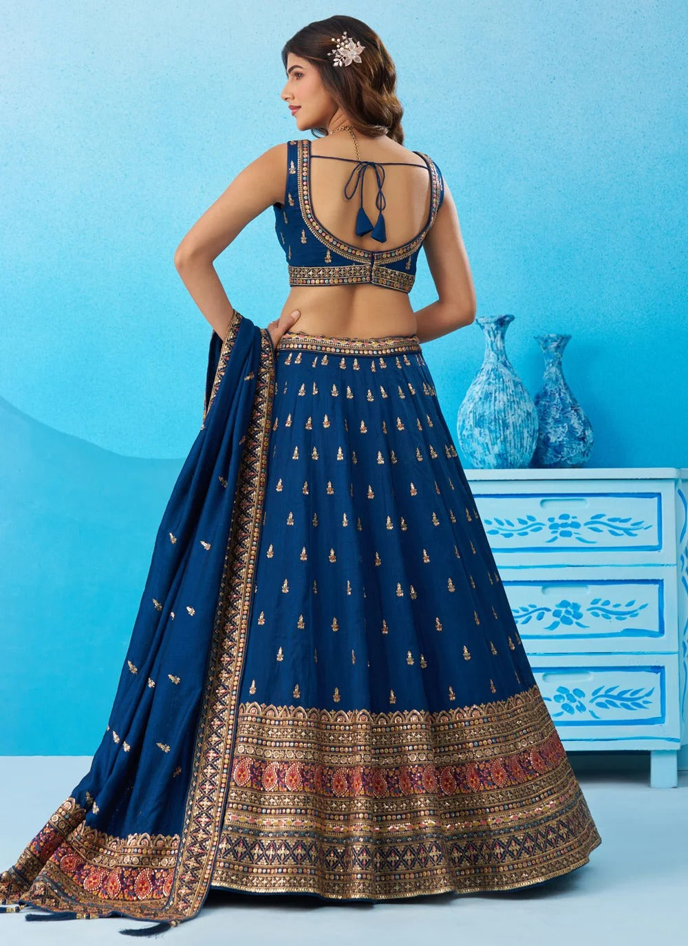Elegant morpeach Chinnon Silk engagement lehenga with intricate zari embroidery and a matching embroidered dupatta.