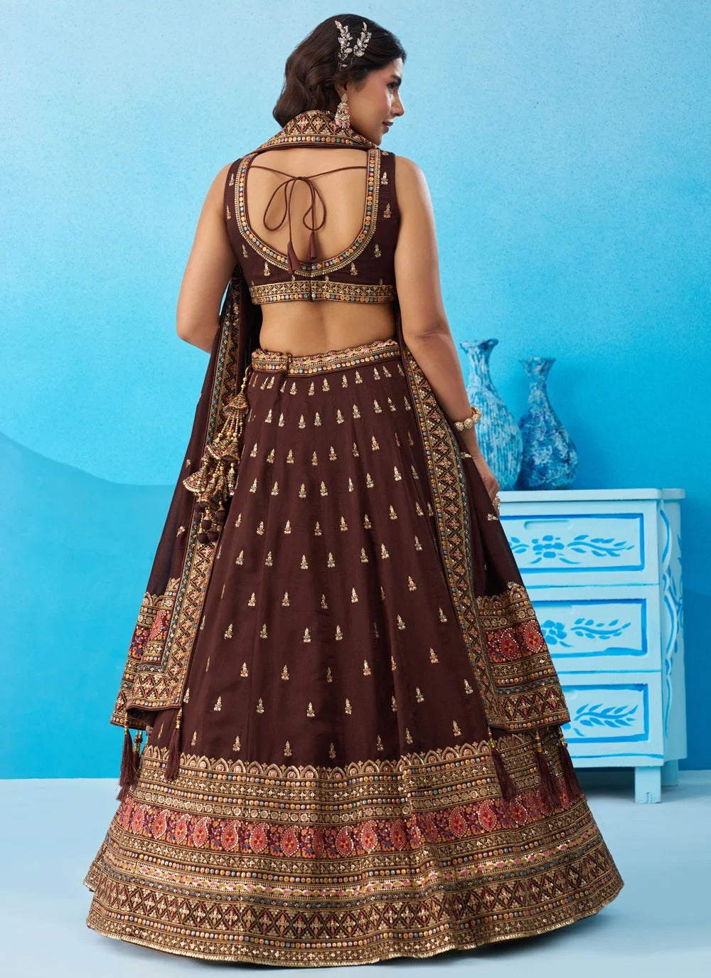 Designer reception lehenga in coffee Chinnon Silk featuring sequins, thread and zari embroidery with a matching embroidered dupatta and tassels.