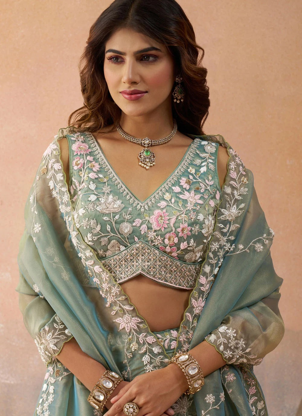 Designer sea green tissue engagement lehenga featuring heavy sequins, coding thread embroidery, colourful cutwork border and a contrasting sky tissue dupatta.