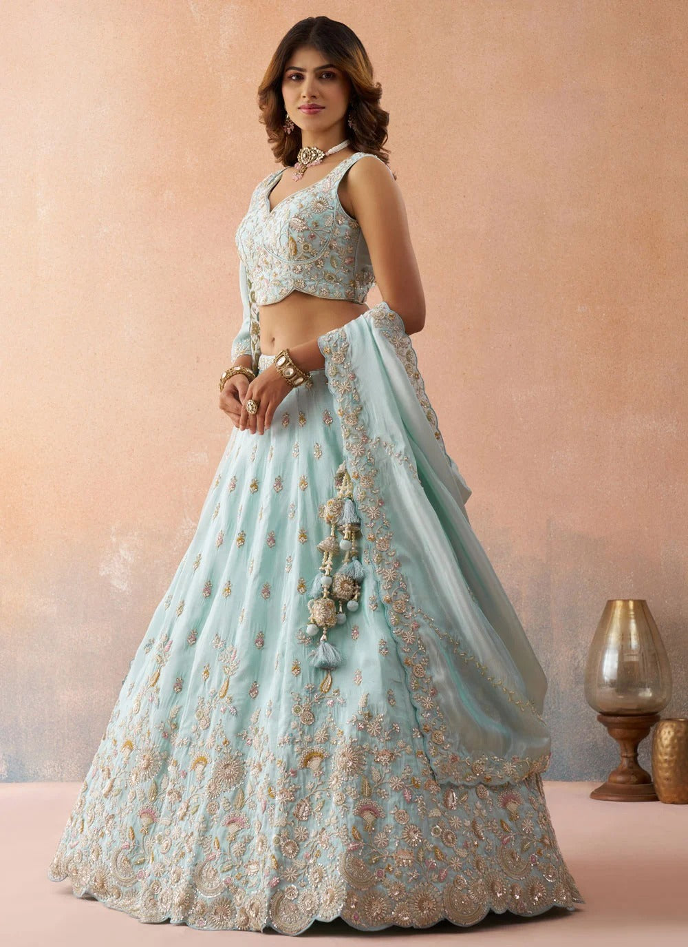 Designer sky blue tissue wedding lehenga featuring heavy sequins, coding thread embroidery, colourful cutwork border and matching embroidered dupatta.