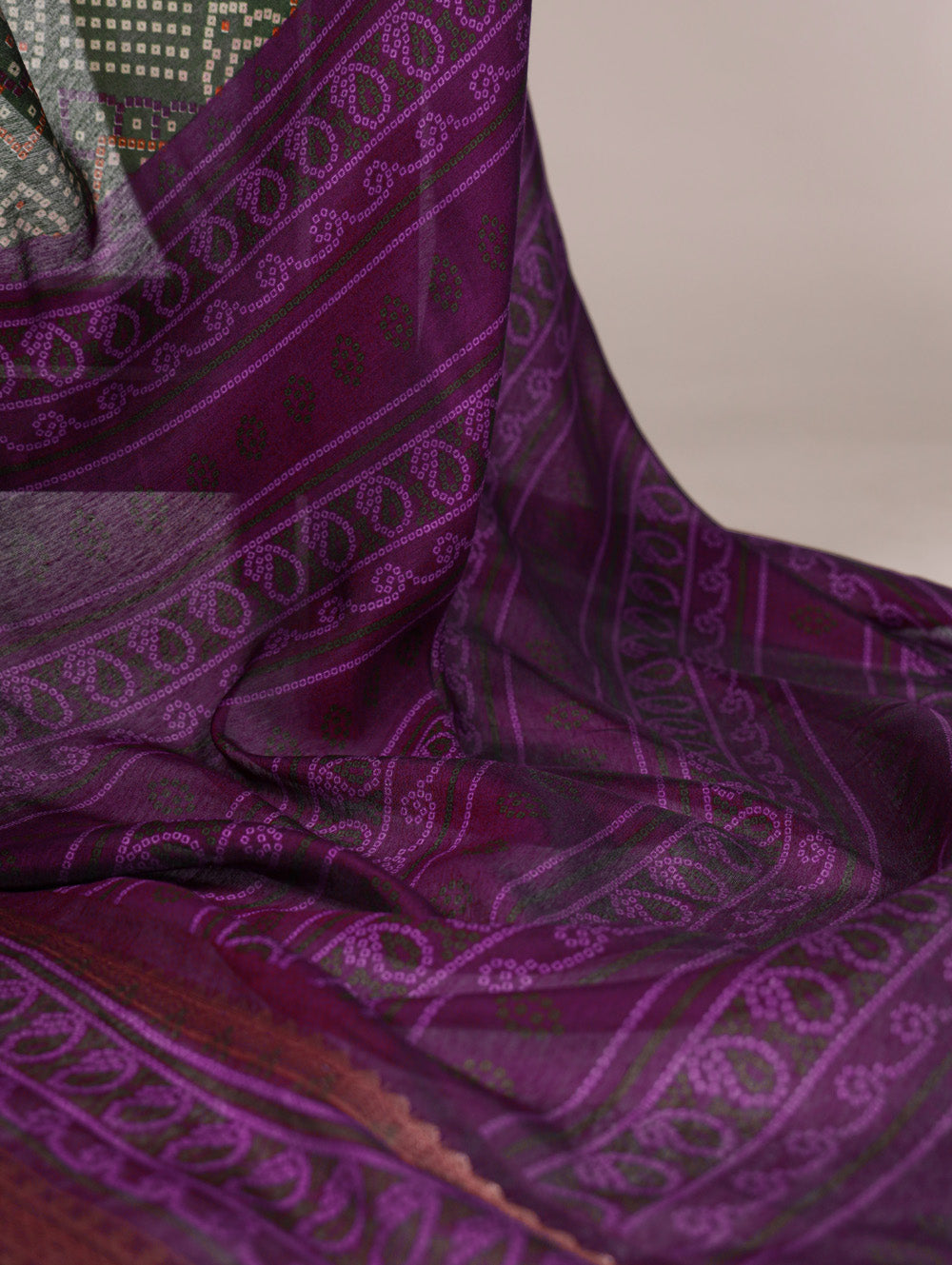 Purple fabric with intricate patterns draped over a surface