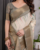 Woman wearing a traditional saree with intricate patterns, holding it with one hand.