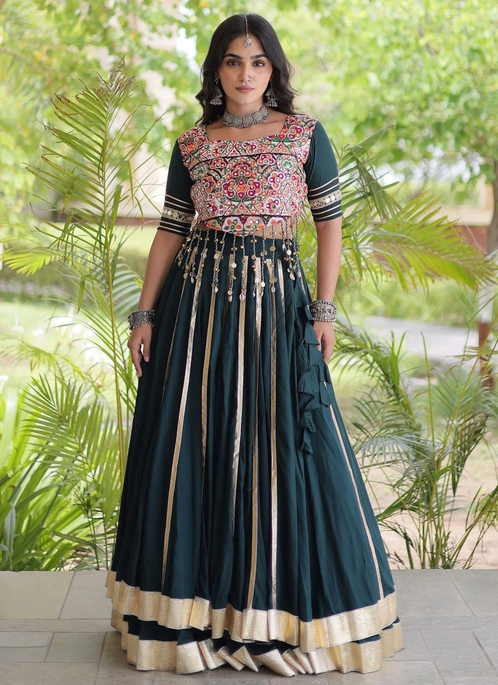 Green full-stitched Gujarati lehenga with mirror work blouse and dori latkan