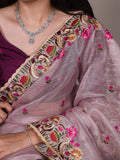 Close-up of a saree with intricate embroidery and a necklace.