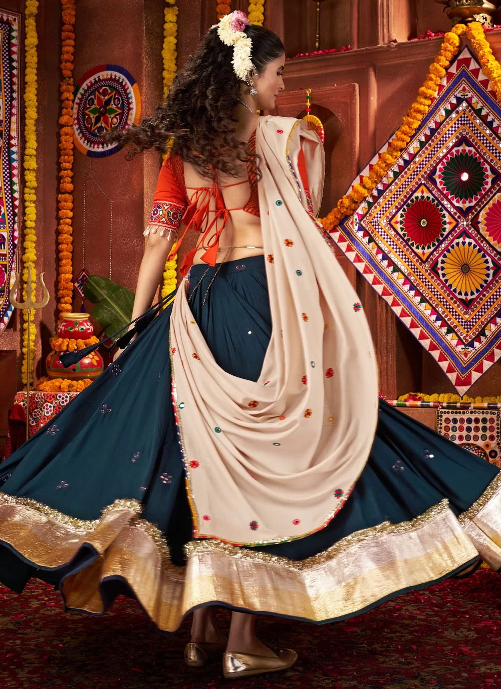 Orange kutchi work blouse with teal blue chaniya choli
