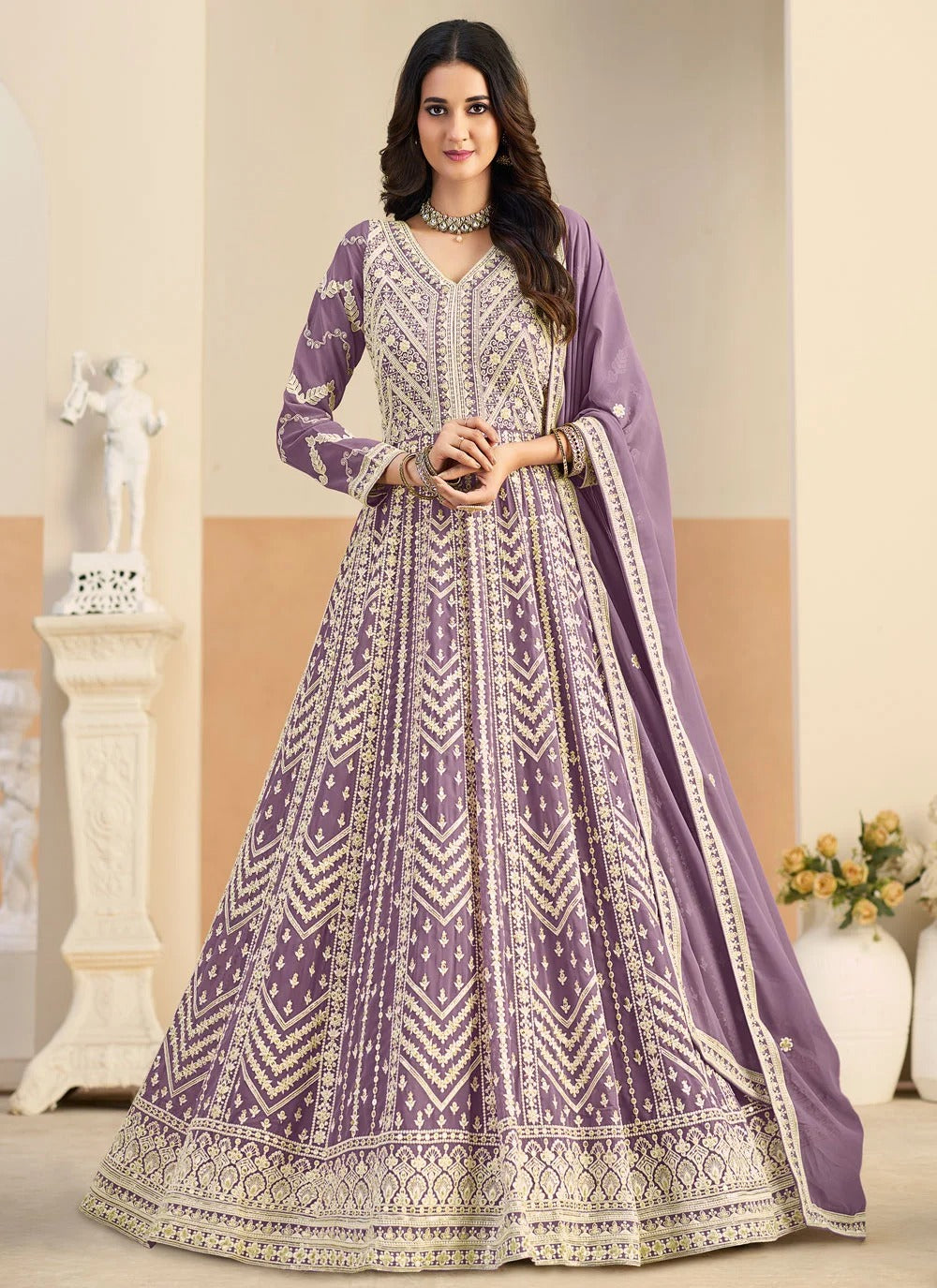 Woman wearing a purple and white patterned dress in an indoor setting