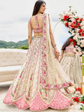 Cream tissue bridesmaid lehenga with sequins, stone work, embroidered blouse and net dupatta, featuring heavy flare and handmade latkan