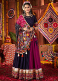Woman in traditional attire with a colorful backdrop