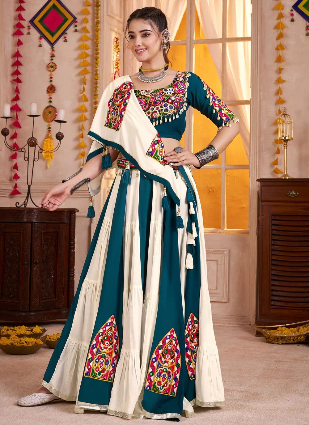 Mirror and kodi embellished teal blue blouse with Kutchi lehenga
