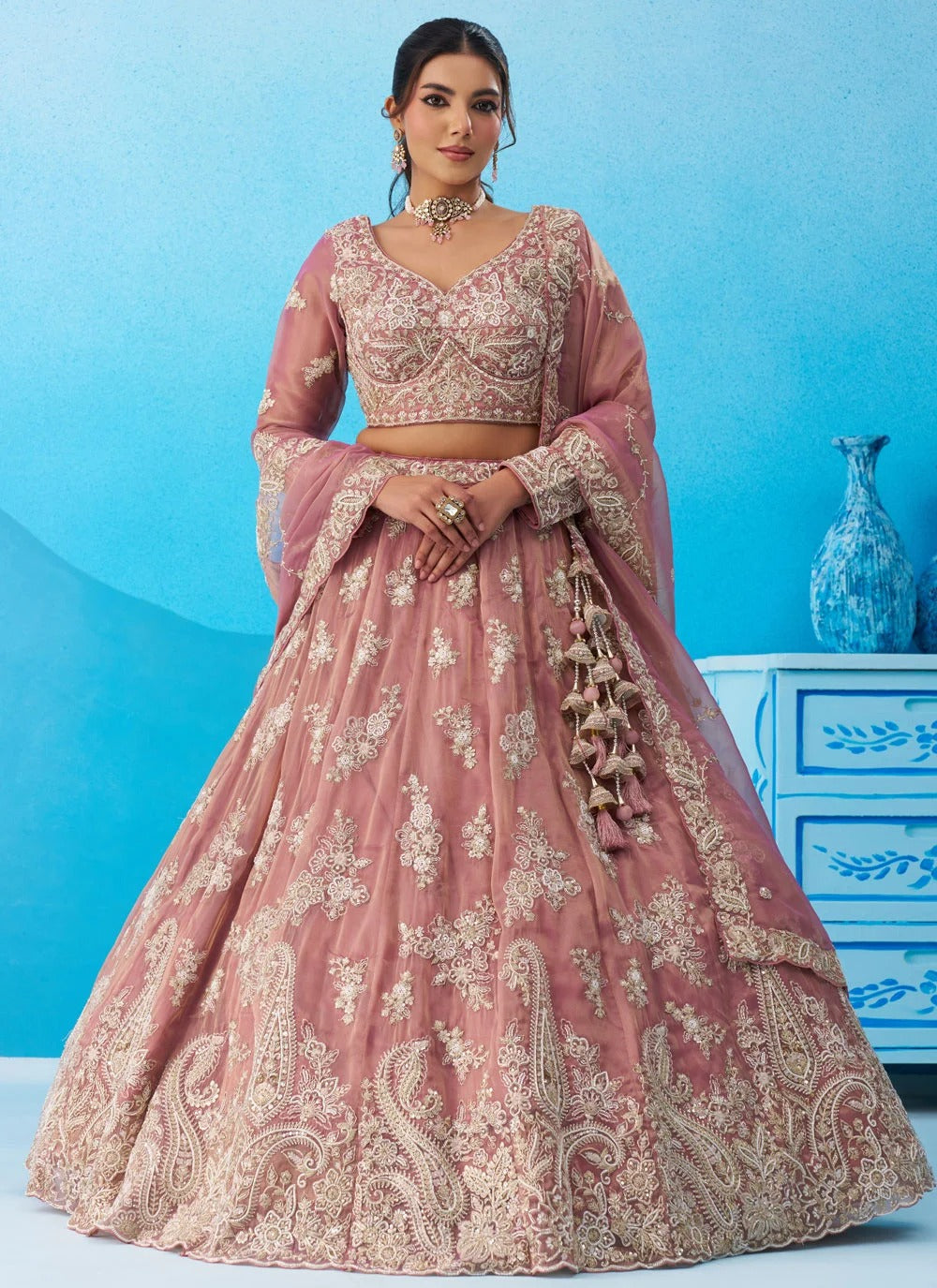 Pink tissue bridal lehenga featuring sequins, coding and thread embroidery with a 4-metre flared silhouette.