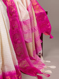 Pink and white traditional fabric with intricate patterns on a gray background