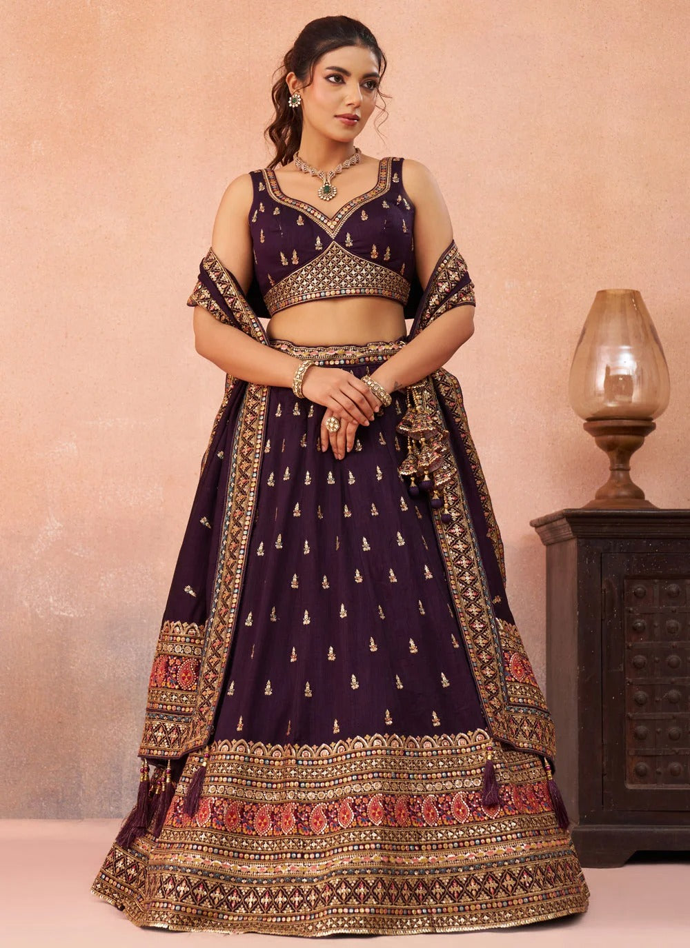 Purple Chinnon Silk lehenga featuring sequins, thread and zari embroidery with a 4-metre flair, matching embroidered dupatta and designer tassels for wedding functions.