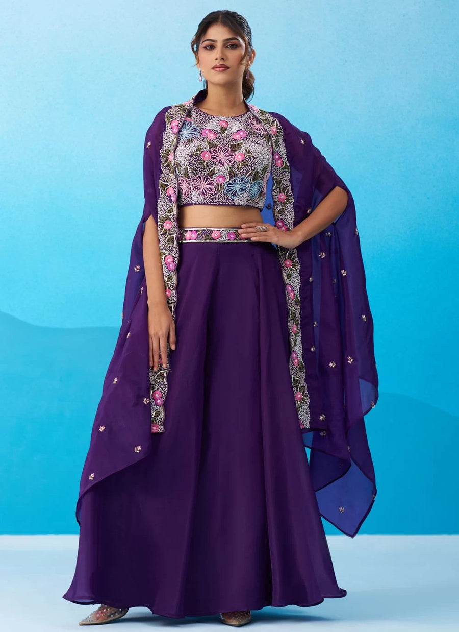 Woman wearing a purple traditional outfit with a floral blouse against a blue background