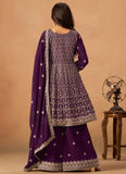 Woman wearing a purple traditional outfit with intricate patterns on a beige background